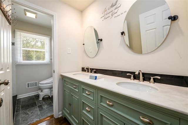 bathroom featuring vanity and toilet