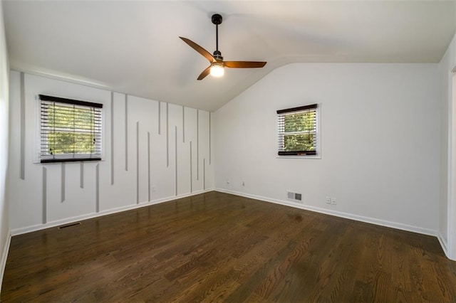 unfurnished bedroom with multiple windows, lofted ceiling, ceiling fan, and dark hardwood / wood-style floors