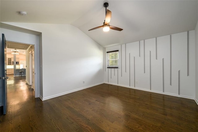 unfurnished bedroom featuring vaulted ceiling, dark hardwood / wood-style flooring, and ceiling fan