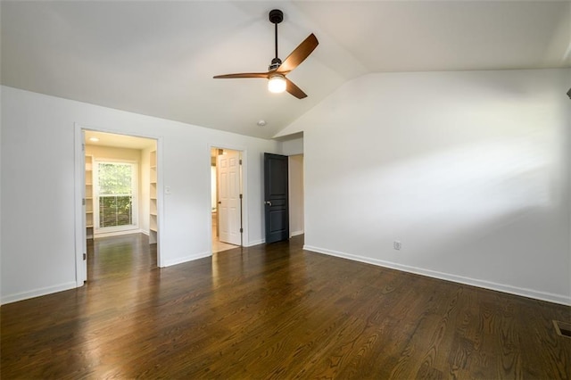 unfurnished room with lofted ceiling, ceiling fan, built in shelves, and dark hardwood / wood-style flooring