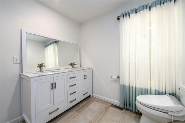 bathroom with tile patterned floors, toilet, and vanity