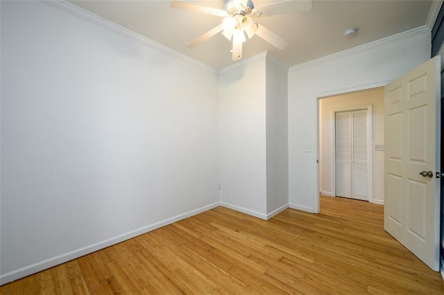 empty room with crown molding, light hardwood / wood-style flooring, and ceiling fan