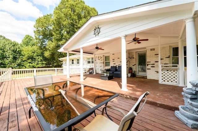 deck with an outdoor living space and ceiling fan