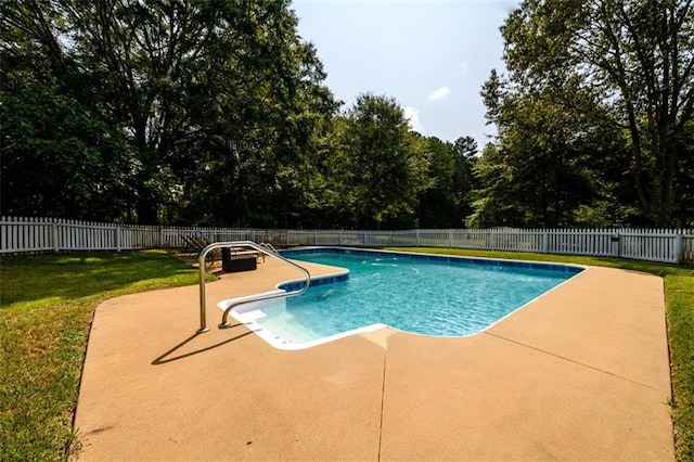 view of pool featuring a lawn and a patio