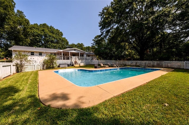 view of pool featuring a patio area and a lawn