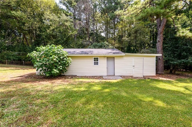 view of outbuilding featuring a lawn