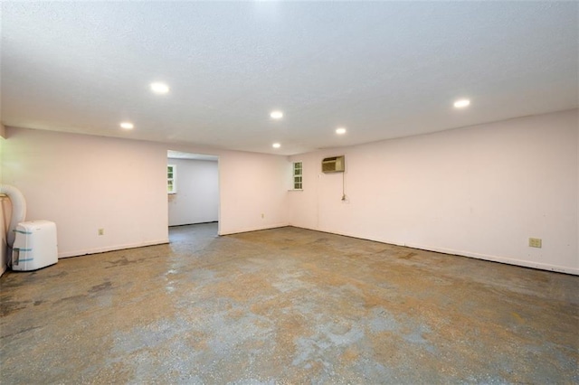 basement featuring a wall mounted air conditioner