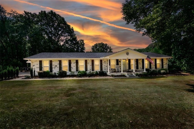 single story home featuring a yard and covered porch