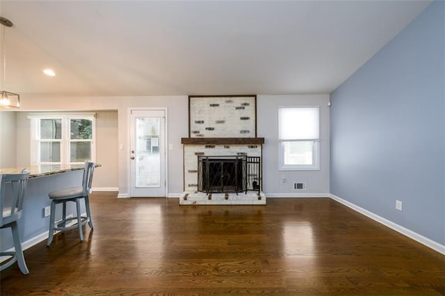 living room with a fireplace and dark hardwood / wood-style floors