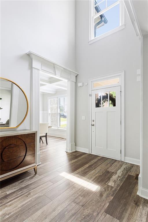 2622 Running River Ct, Lawrenceville, GA 30045 - foyer with wood finished floors, a towering ceiling, healthy amount of natural light, and baseboards