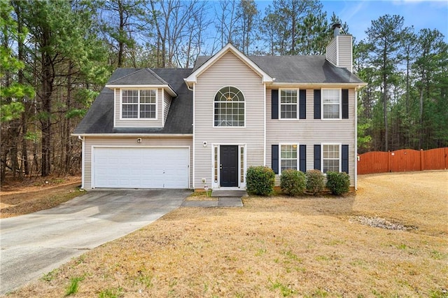 colonial inspired home with a garage, fence, driveway, a front lawn, and a chimney