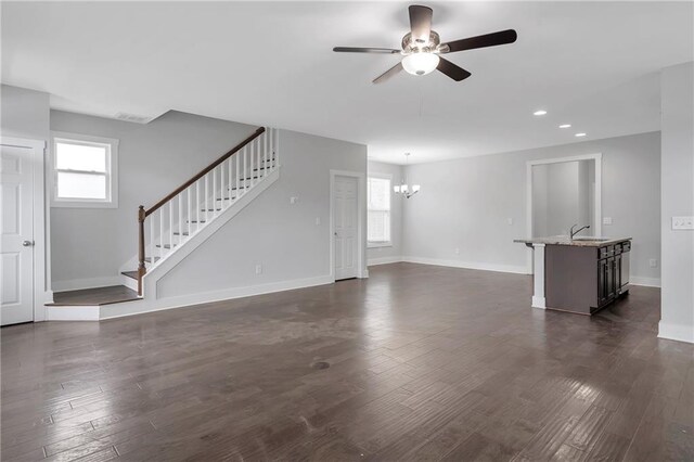 unfurnished living room with a ceiling fan, stairs, dark wood-style floors, recessed lighting, and baseboards