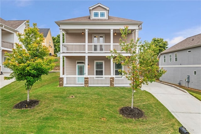 view of front of house featuring a porch, a balcony, and a front lawn