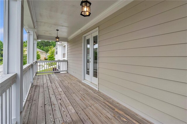 wooden terrace featuring covered porch
