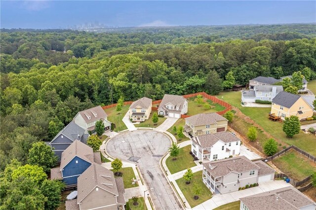 aerial view of residential area featuring a heavily wooded area