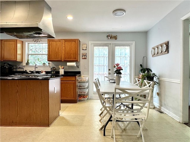 627 Arbour Way, Suwanee, GA 30024 - kitchen with wall chimney exhaust hood, dark countertops, brown cabinets, a sink, and recessed lighting