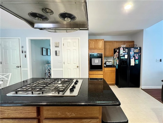 627 Arbour Way, Suwanee, GA 30024 - kitchen with black appliances, brown cabinetry, ventilation hood, dark stone counters, and baseboards