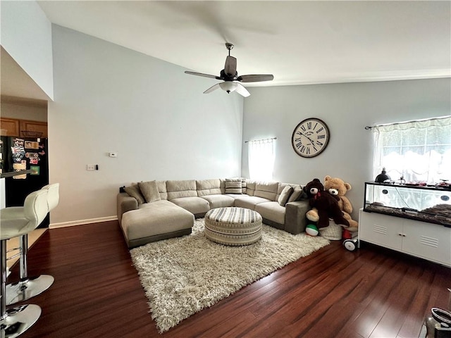 627 Arbour Way, Suwanee, GA 30024 - living room featuring wood finished floors, healthy amount of natural light, ceiling fan, vaulted ceiling, and baseboards