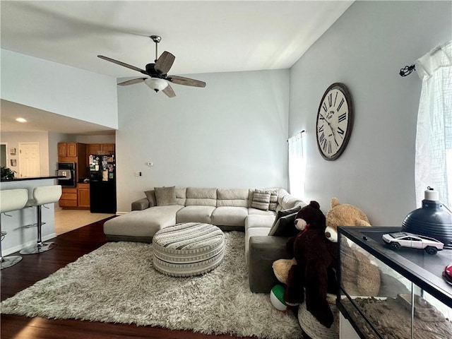 627 Arbour Way, Suwanee, GA 30024 - living area with vaulted ceiling, wood finished floors, and a ceiling fan