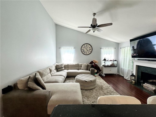 627 Arbour Way, Suwanee, GA 30024 - living room featuring dark wood-type flooring, a ceiling fan, lofted ceiling, and a fireplace with flush hearth