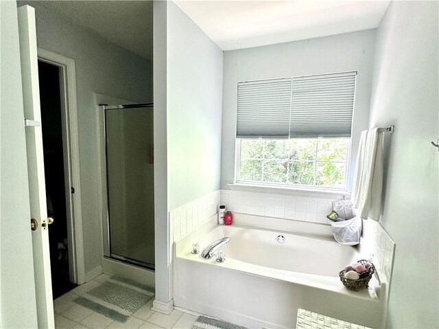 627 Arbour Way, Suwanee, GA 30024 - full bath featuring a bath, tile patterned floors, and a stall shower