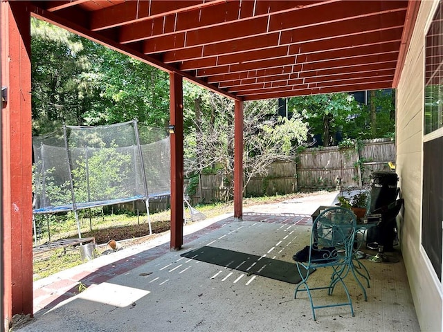 627 Arbour Way, Suwanee, GA 30024 - fenced backyard featuring a trampoline and a patio