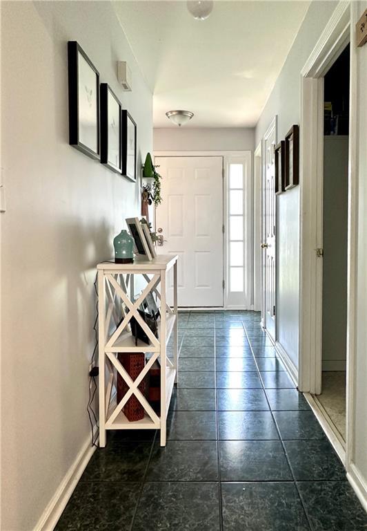 627 Arbour Way, Suwanee, GA 30024 - foyer featuring baseboards and dark tile patterned floors