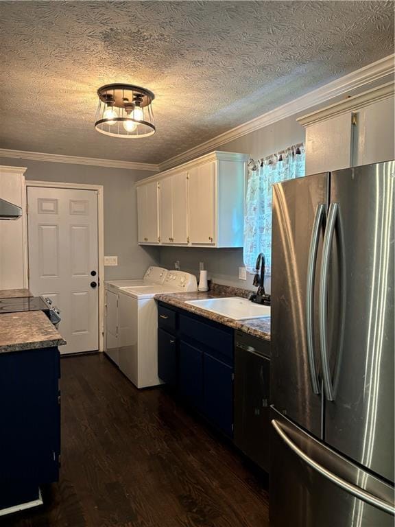 kitchen featuring crown molding, white cabinetry, stainless steel refrigerator, sink, and washer and clothes dryer