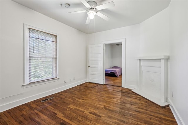 unfurnished bedroom with wood finished floors, baseboards, and ceiling fan
