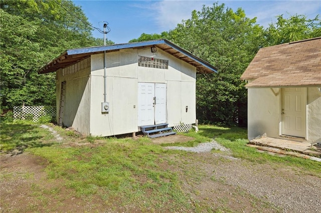 view of outbuilding featuring entry steps and an outbuilding