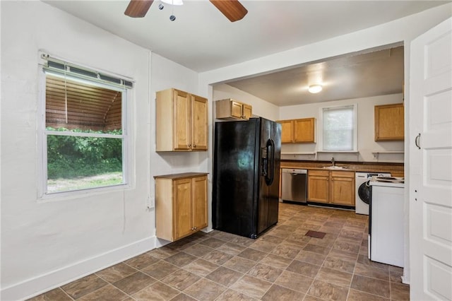kitchen featuring black fridge with ice dispenser, dishwasher, ceiling fan, a sink, and baseboards