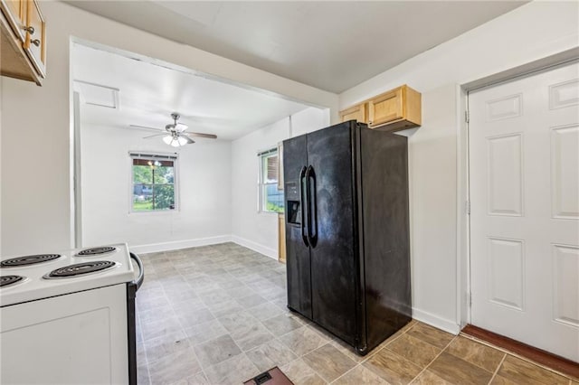 kitchen with black fridge, electric stove, baseboards, and ceiling fan
