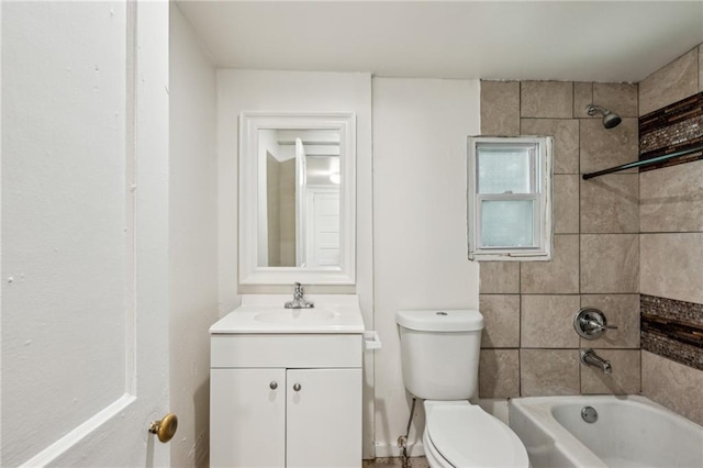 bathroom featuring vanity, toilet, and washtub / shower combination