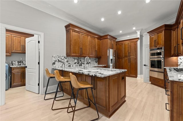 kitchen with stainless steel appliances, a peninsula, a warming drawer, and crown molding