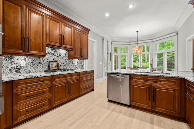kitchen with light wood finished floors, a sink, stainless steel appliances, and tasteful backsplash
