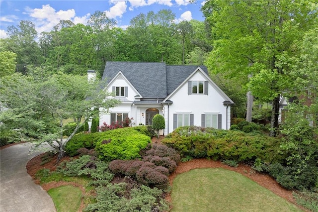 view of front of home featuring stucco siding and a chimney
