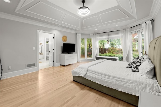 bedroom featuring visible vents, ornamental molding, light wood-type flooring, and multiple windows