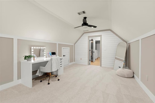 home office with carpet flooring, ceiling fan, lofted ceiling, and visible vents