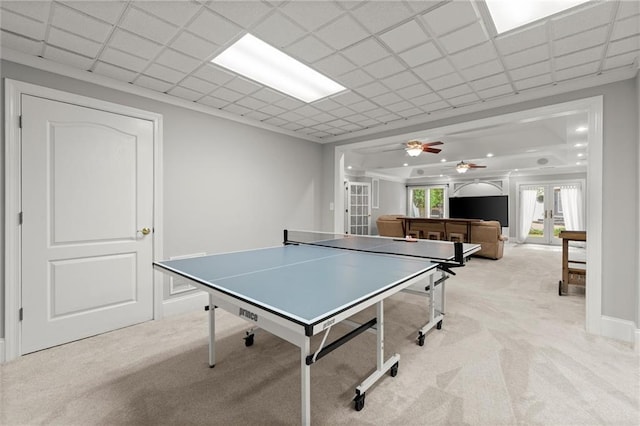 playroom featuring a ceiling fan, french doors, and light colored carpet