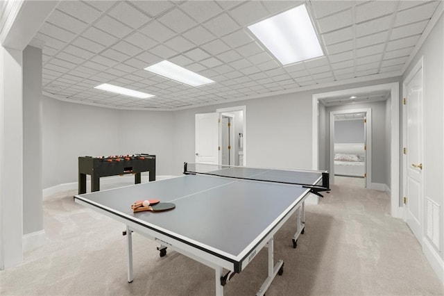 playroom featuring a drop ceiling, light colored carpet, and baseboards