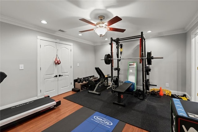 workout room featuring ornamental molding, recessed lighting, a ceiling fan, and wood finished floors