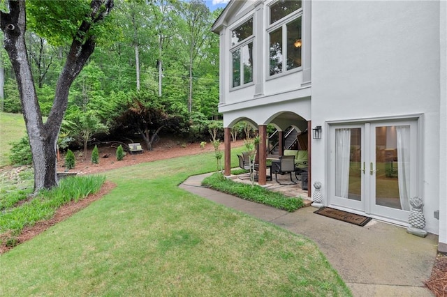 view of yard with french doors and a patio area