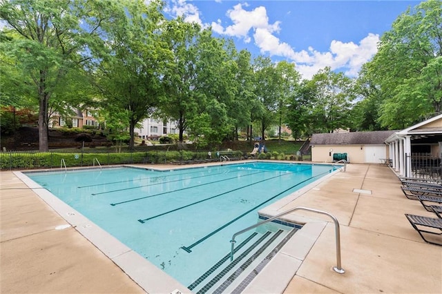 pool featuring a patio area and fence