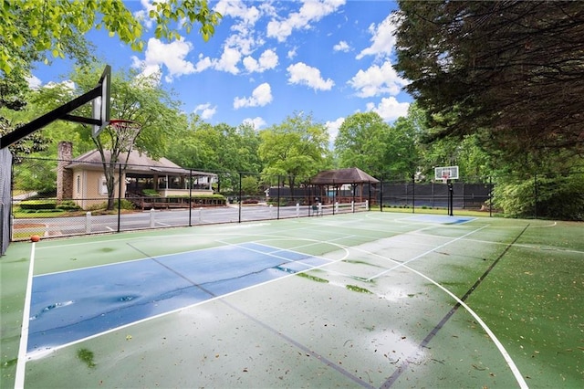 view of sport court with fence, a gazebo, a tennis court, and community basketball court