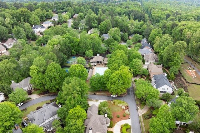 bird's eye view with a wooded view and a residential view