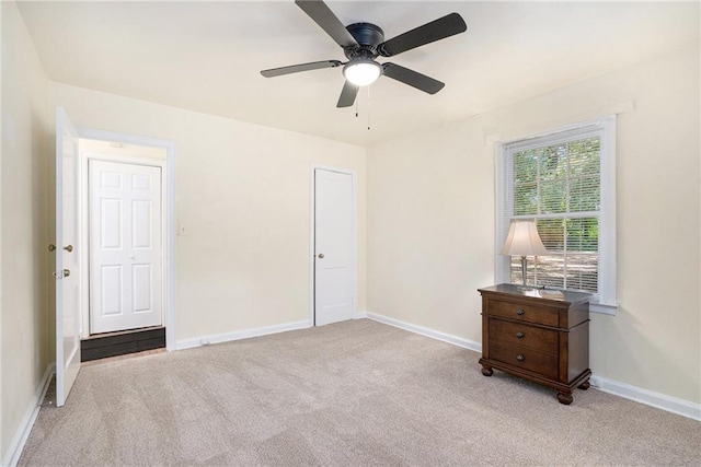 unfurnished bedroom with ceiling fan and light carpet