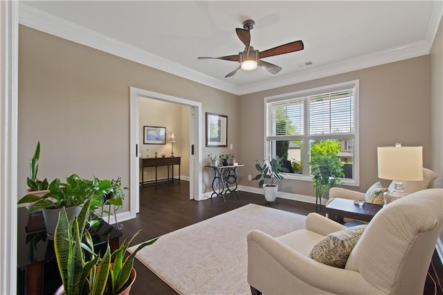 living room with crown molding, ceiling fan, visible vents, and baseboards