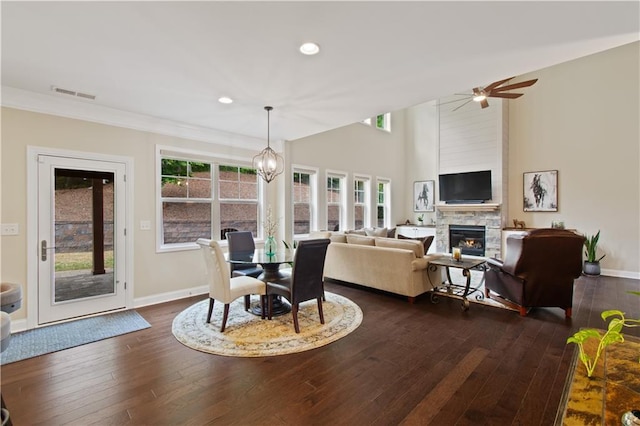 dining space featuring a fireplace, recessed lighting, baseboards, dark wood-type flooring, and visible vents