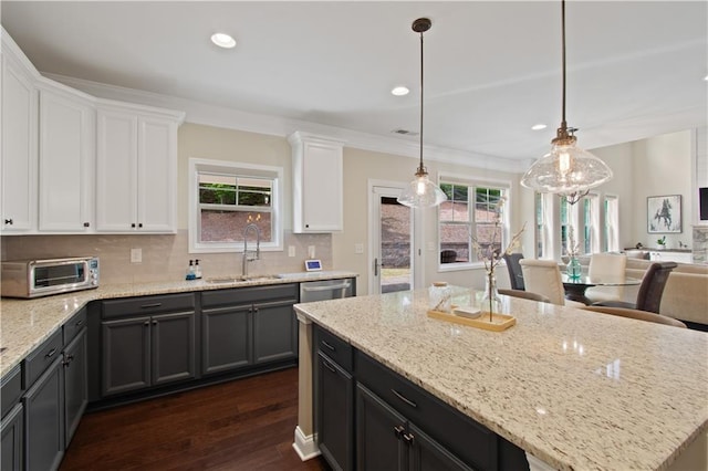 kitchen featuring white cabinetry, tasteful backsplash, a sink, and dark wood-type flooring