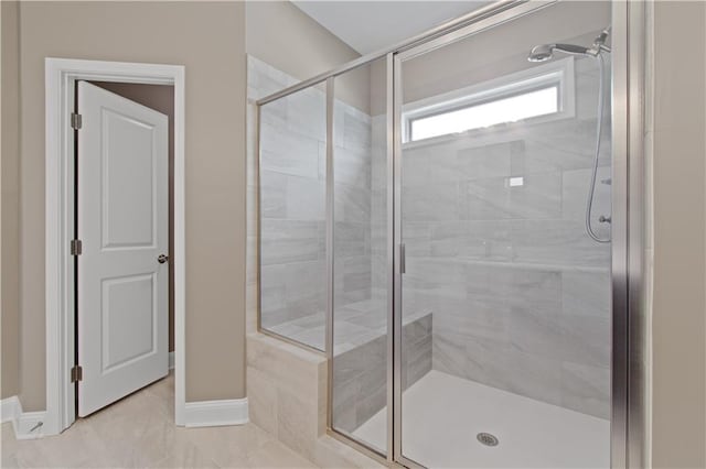 full bathroom with baseboards and a stall shower